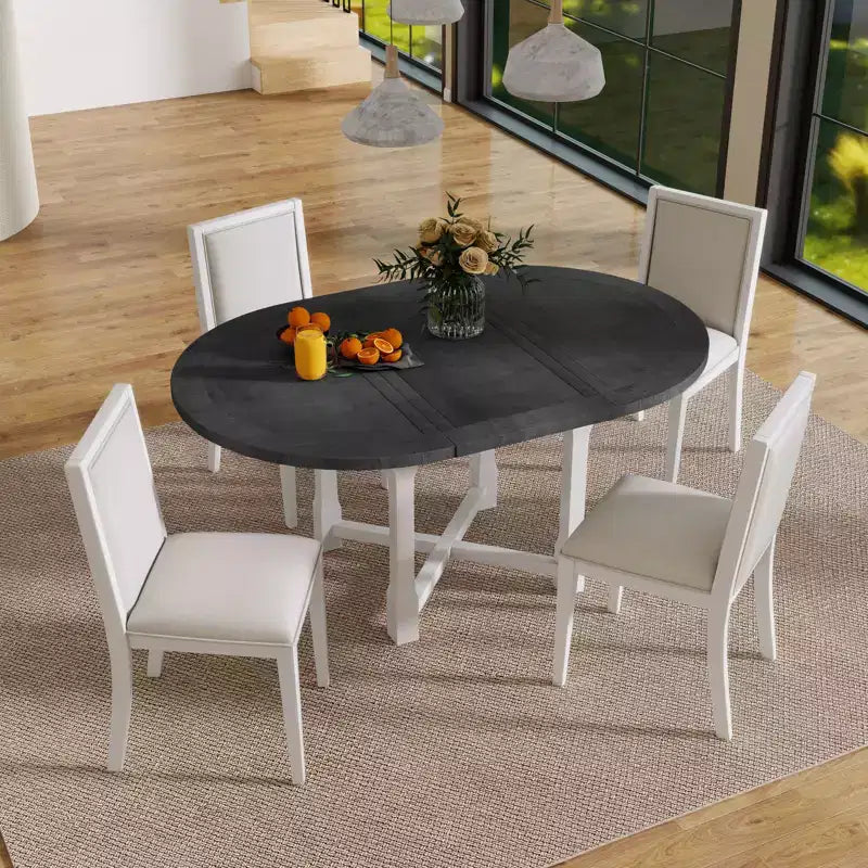 Ensemble de salle à manger 5 pièces Judith GDFStudio avec table ronde extensible et chaises rembourrées
